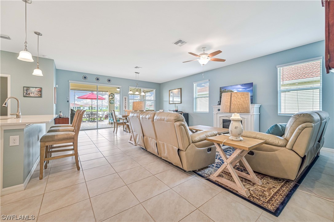 3435 Gold Flower Street Fort Myers, FL 33905 - Photo 11 of 39 a living room with furniture a dining table and a piano table