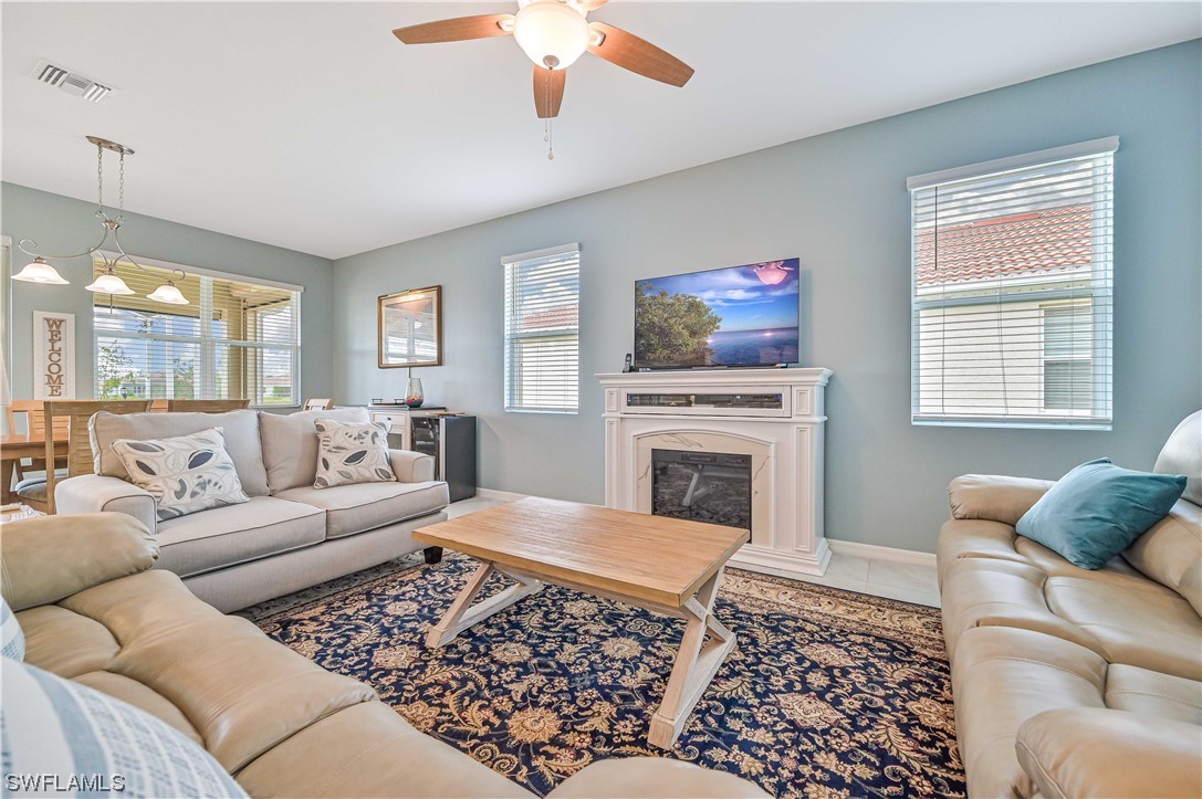 3435 Gold Flower Street Fort Myers, FL 33905 - Photo 12 of 39 a living room with furniture a rug and a fireplace