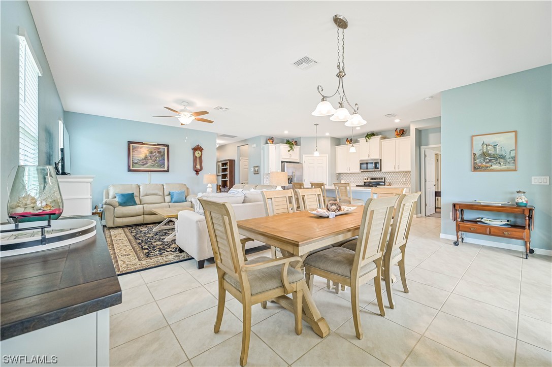 3435 Gold Flower Street Fort Myers, FL 33905 - Photo 19 of 39 a view of a dining room with furniture and a chandelier