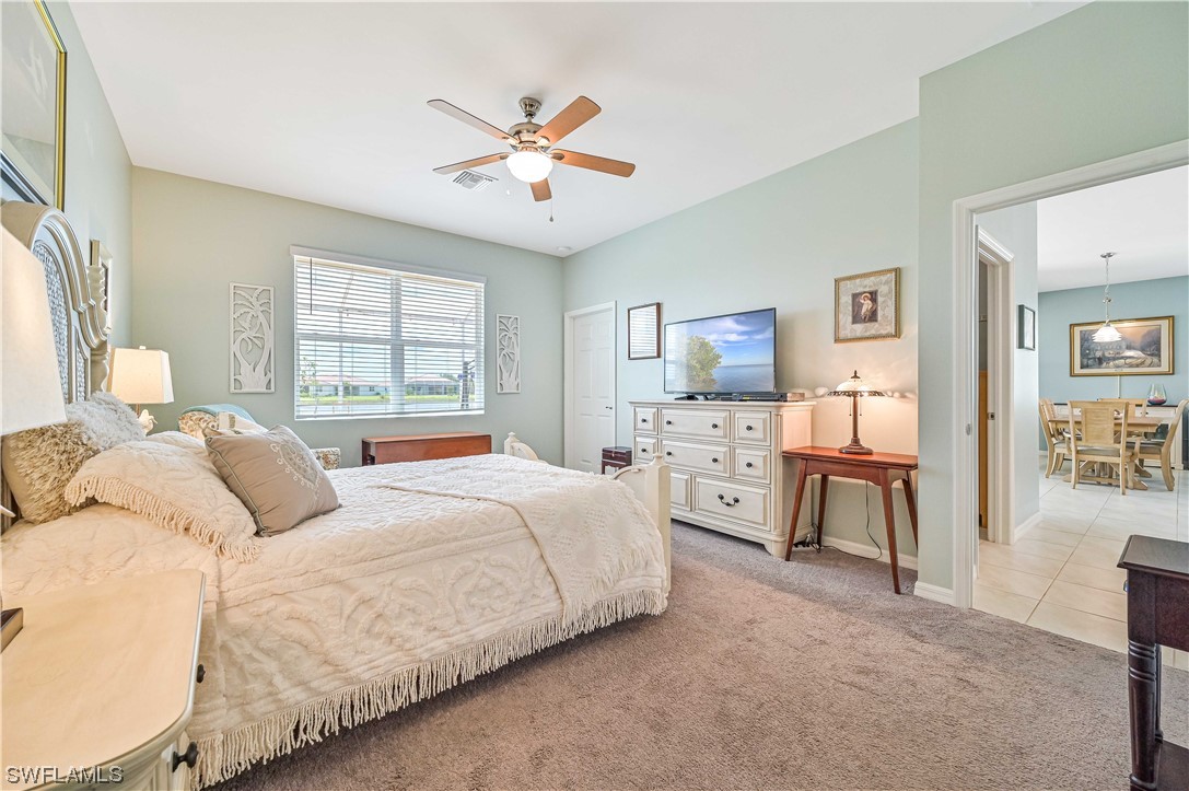 3435 Gold Flower Street Fort Myers, FL 33905 - Photo 26 of 39 a bedroom with a bed and a chandelier