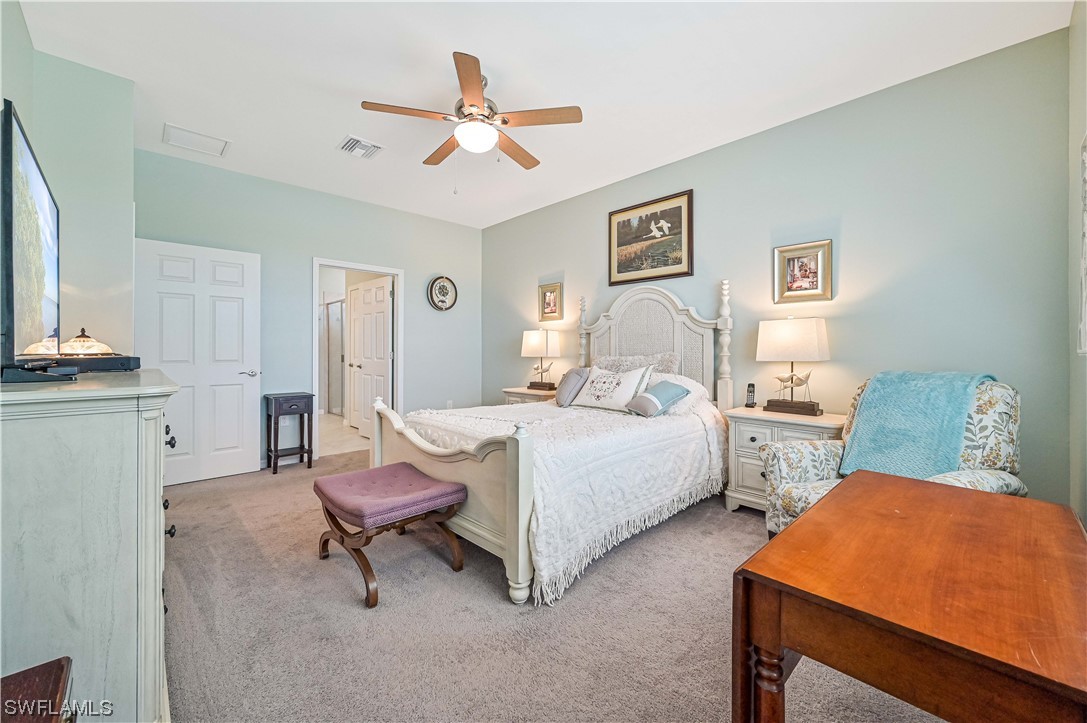 3435 Gold Flower Street Fort Myers, FL 33905 - Photo 27 of 39 a bedroom with a bed and a table in it