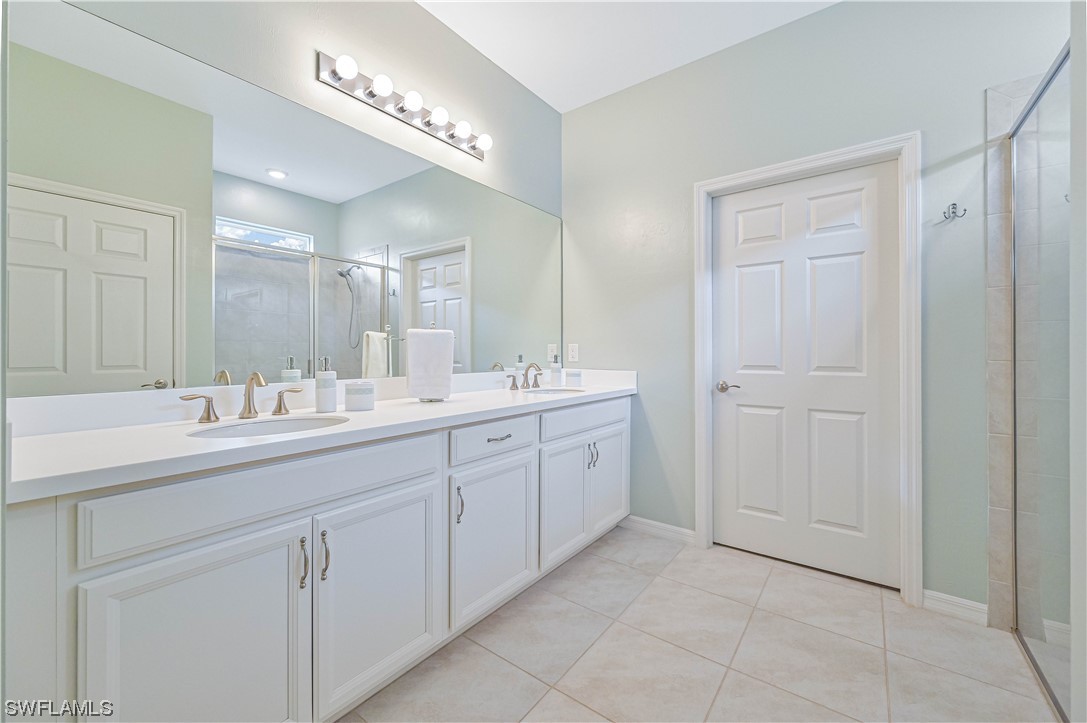 3435 Gold Flower Street Fort Myers, FL 33905 - Photo 28 of 39 a bathroom with a double vanity sink and a mirror