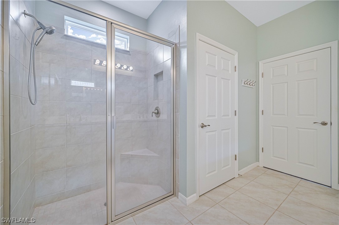 3435 Gold Flower Street Fort Myers, FL 33905 - Photo 29 of 39 a bathroom with a glass shower door