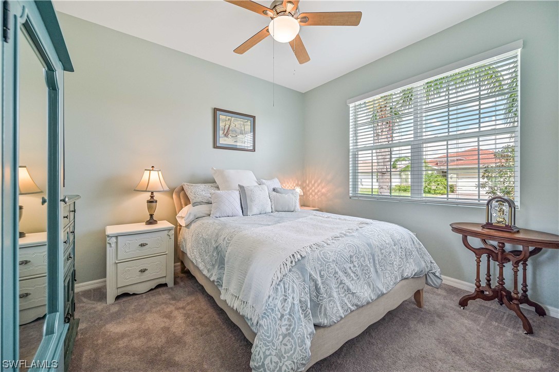 3435 Gold Flower Street Fort Myers, FL 33905 - Photo 32 of 39 a bedroom with a bed and a table in it