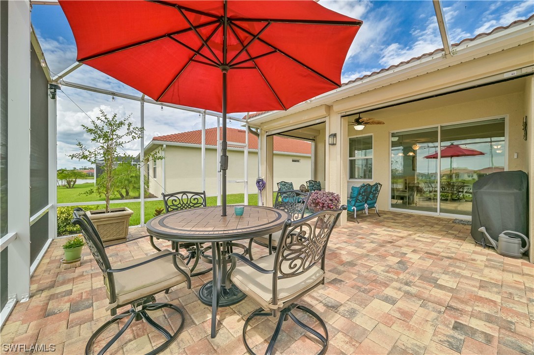 3435 Gold Flower Street Fort Myers, FL 33905 - Photo 7 of 39 a view of a patio with a table and chairs under an umbrella