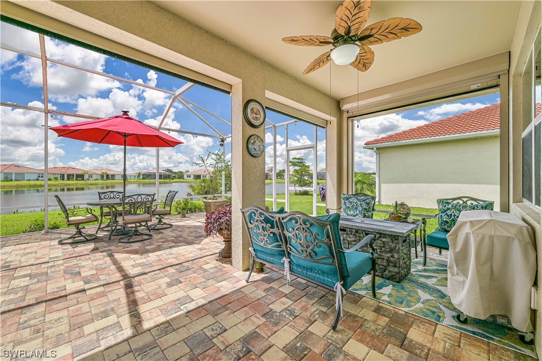 3435 Gold Flower Street Fort Myers, FL 33905 - Photo 8 of 39 a view of a patio with a table chairs and a floor to ceiling window