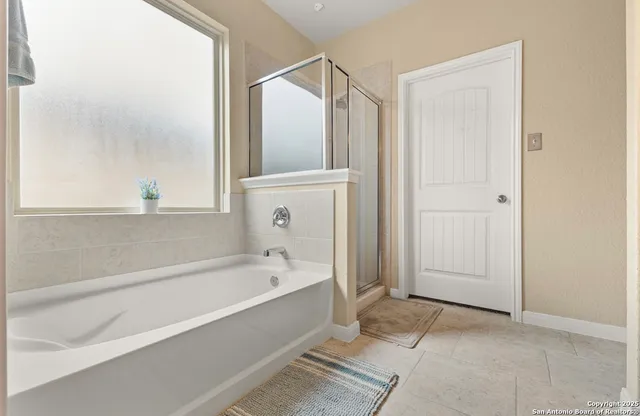 a bathroom with a bathtub and a shower