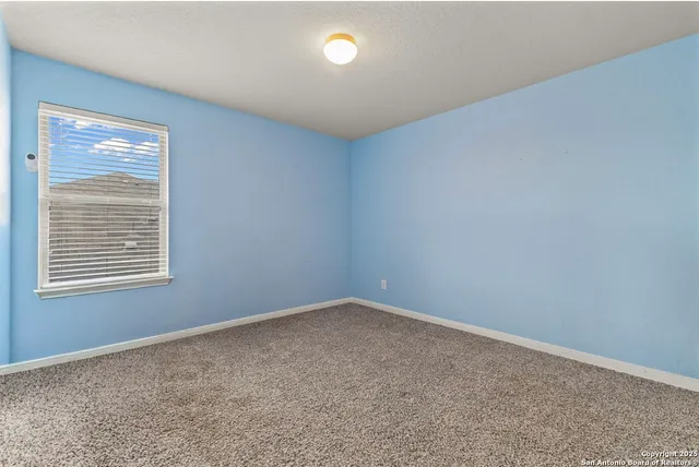 an empty room with a fan