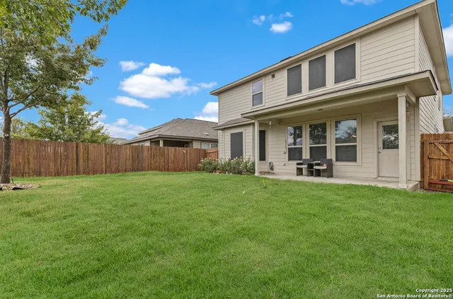 a view of a house with backyard and porch
