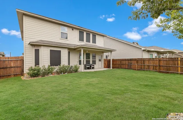 a view of a house with a backyard