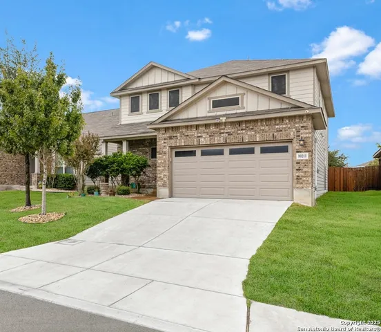 a front view of a house with a yard and garage