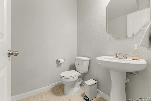 a bathroom with a sink toilet and a mirror