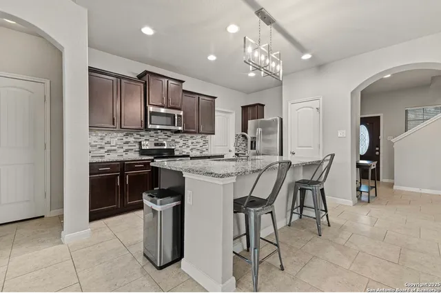 a kitchen with a sink cabinets and stainless steel appliances