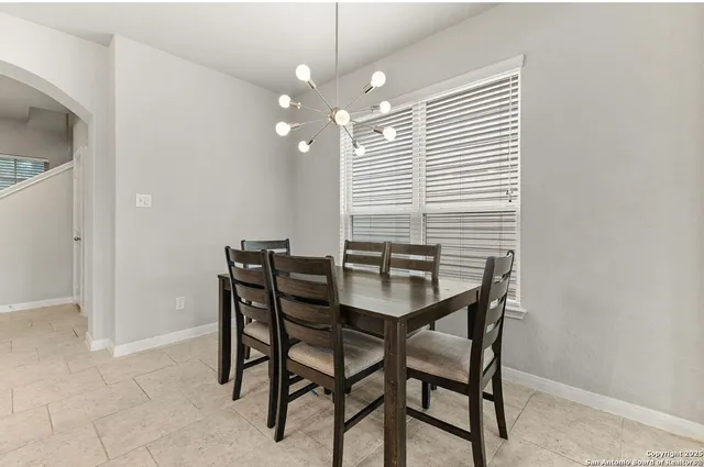 a view of a dining room with furniture and chandelier