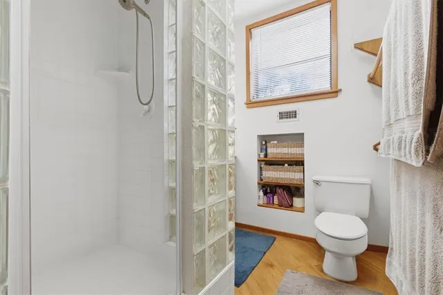 a bathroom with a toilet a sink and mirror