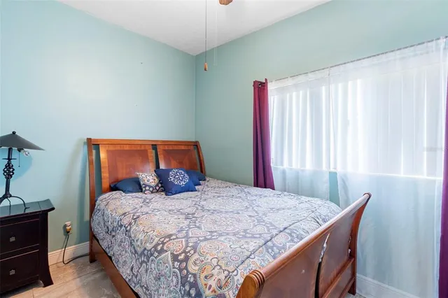 a bedroom with a bed and a window