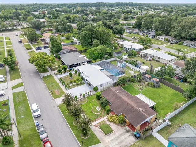 an aerial view of a house with a garden and lake view