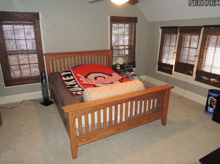 804 Raff Road Southwest Canton, OH 44710 - Photo 12 of 17 Spacious bedroom with angled ceilings, carpet, lots of windows, and lighted ceiling fan.