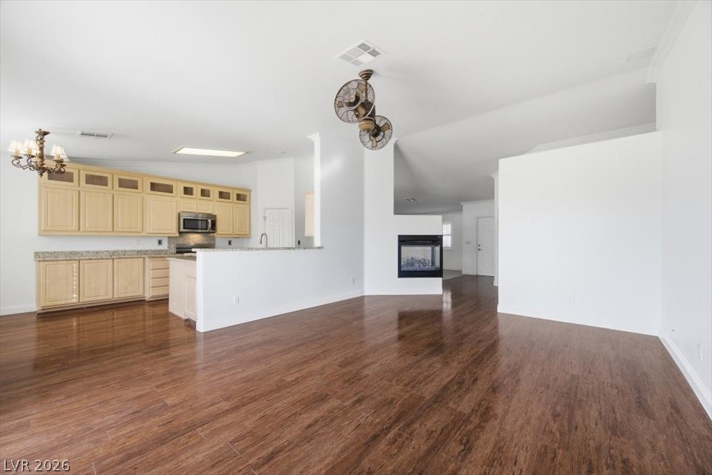 573 Beryl Court Henderson, NV 89015 - Photo 16 of 52 Separate family room with vaulted ceilings, laminate floors and a 3-way fireplace.
