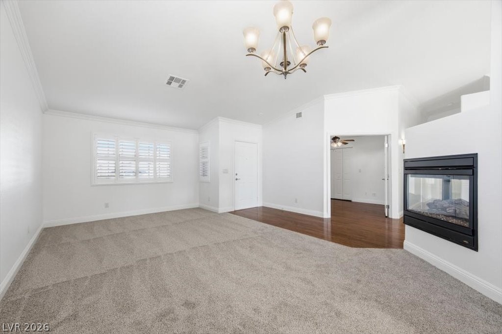 573 Beryl Court Henderson, NV 89015 - Photo 17 of 52 Formal living room with brand new carpet, 3 way gas fireplace and vaulted ceilings.