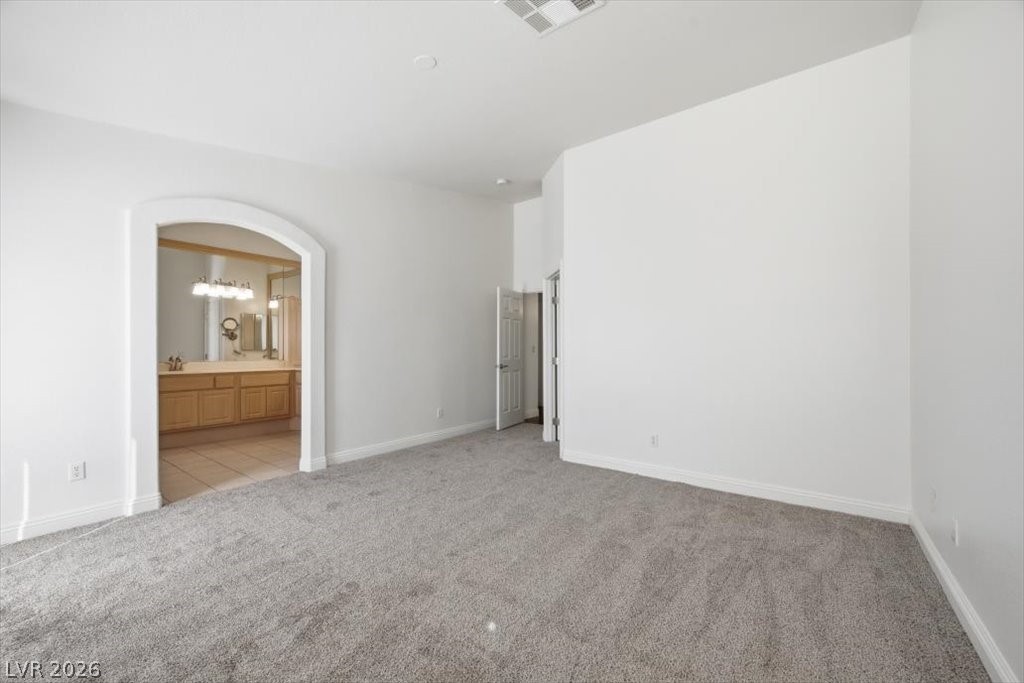 573 Beryl Court Henderson, NV 89015 - Photo 31 of 52 Plenty of room for the King size bed and all the extras in this primary bedroom.