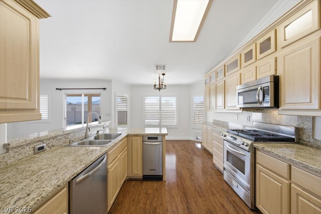 573 Beryl Court Henderson, NV 89015 - Photo 7 of 52 Plenty of cabinets and counter space with granite countertops, stainless steel appliances plus a trash compactor.