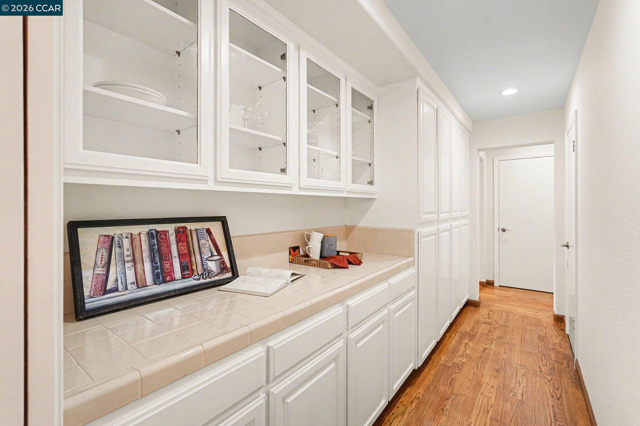 4885 Milden Road Martinez, CA 94553 - Photo 19 of 52 a hallway with a white cabinets and wooden floor
