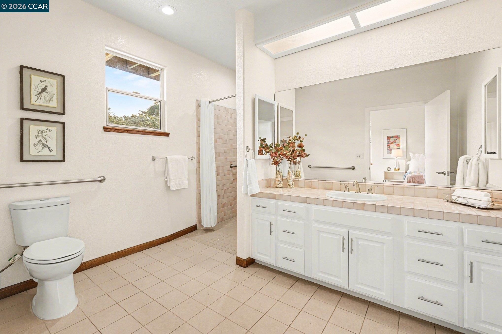 4885 Milden Road Martinez, CA 94553 - Photo 24 of 52 a spacious bathroom with a toilet a sink and a mirror