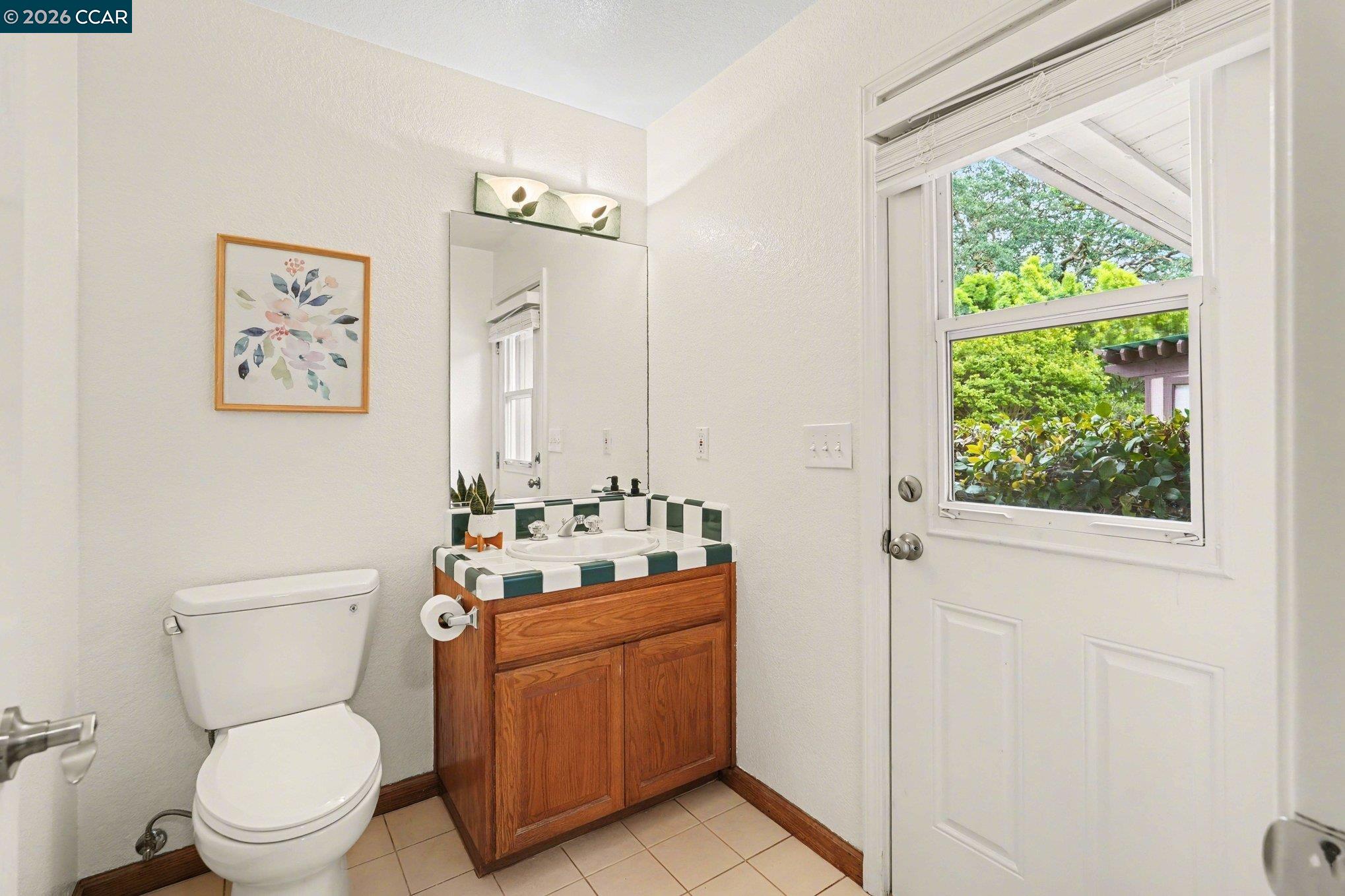 4885 Milden Road Martinez, CA 94553 - Photo 31 of 52 a bathroom with a toilet a sink and a window