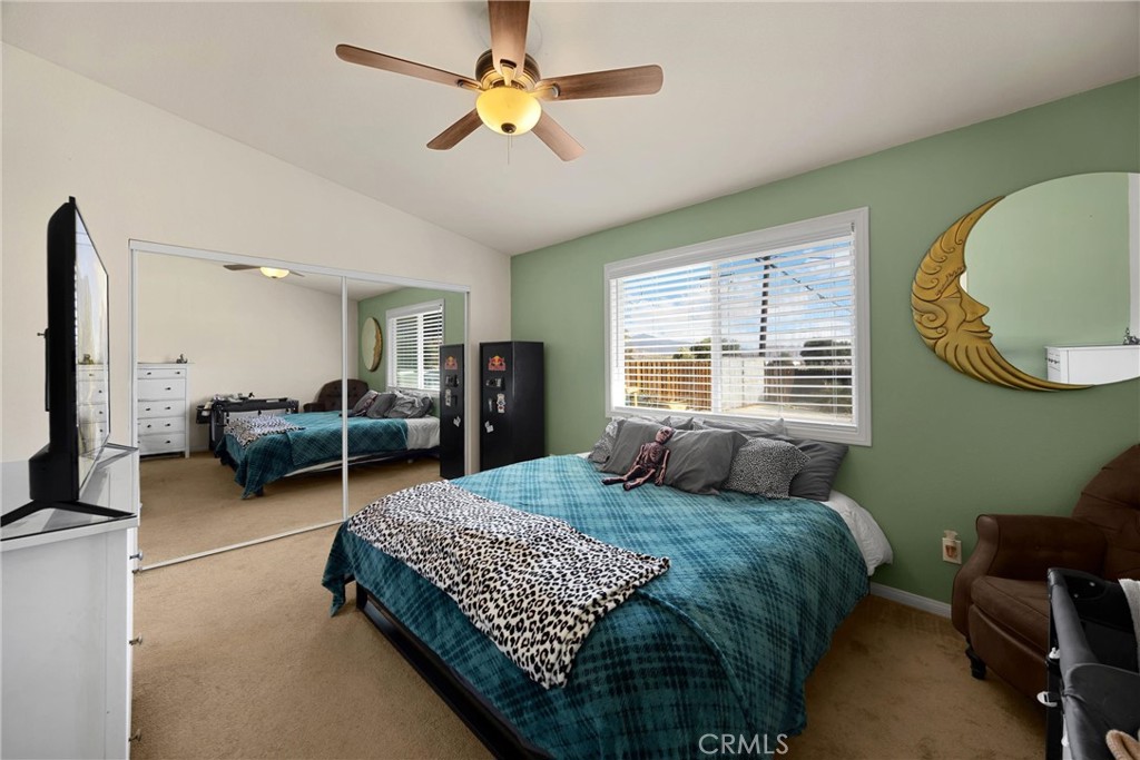 14508 Cabazon Street Cabazon, CA 92230 - Photo 14 of 22 a bedroom with a bed mirror and a window