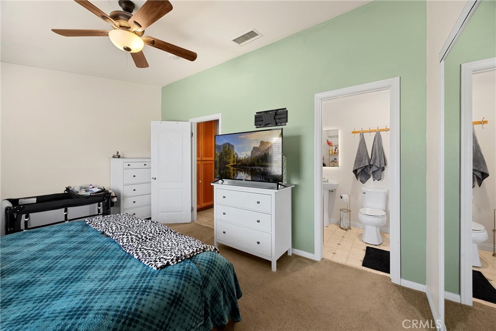 14508 Cabazon Street Cabazon, CA 92230 - Photo 15 of 22 a bedroom with a bed and a chandelier