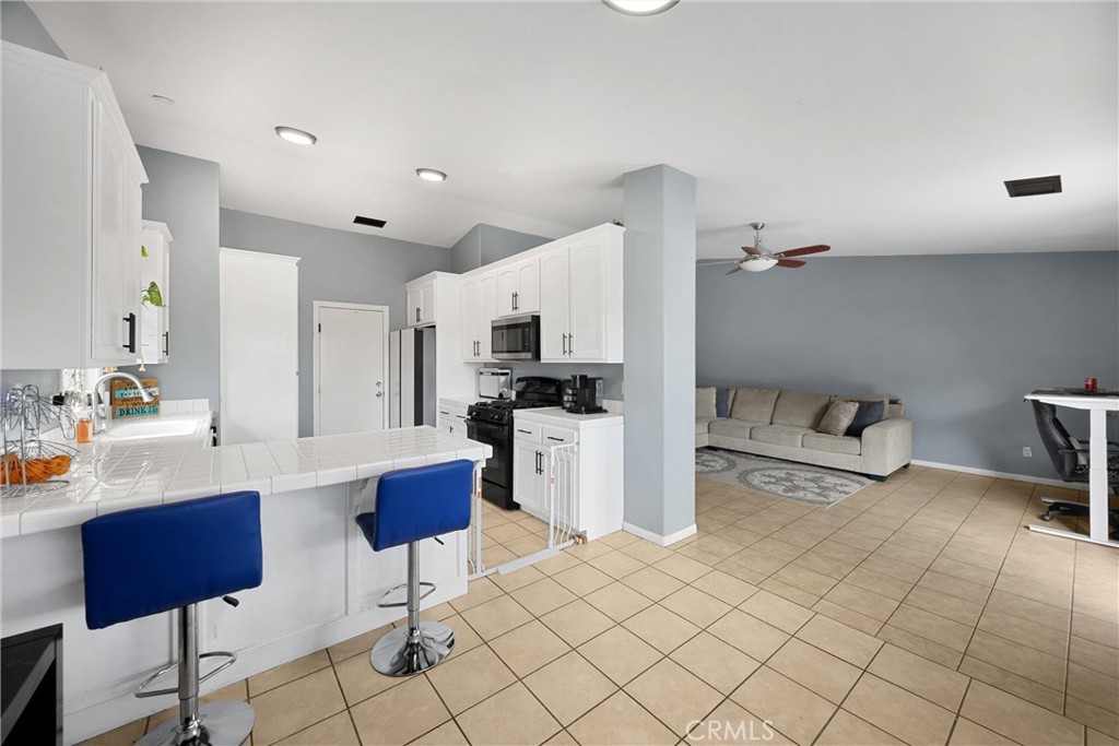 14508 Cabazon Street Cabazon, CA 92230 - Photo 7 of 22 a kitchen with cabinets and chairs