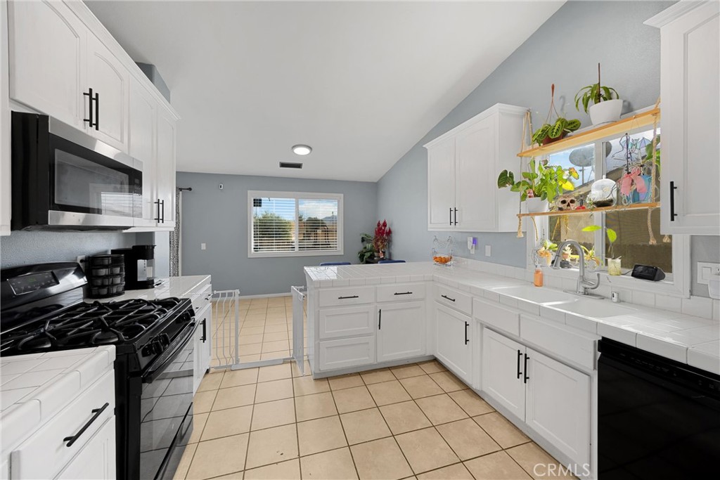 14508 Cabazon Street Cabazon, CA 92230 - Photo 9 of 22 a kitchen with stainless steel appliances a sink window and cabinets