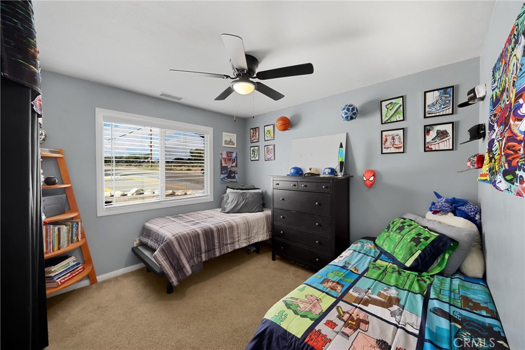 14508 Cabazon Street Cabazon, CA 92230 - Photo 10 of 22 a bedroom with a bed and a wooden floor