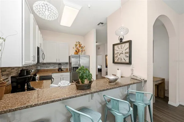a dining room with furniture and a mirror