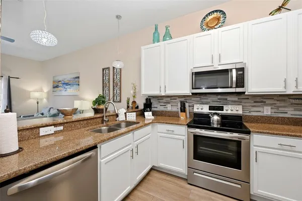 a kitchen with a sink stove and microwave