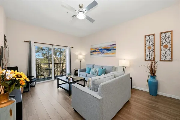 a living room with furniture and wooden floor