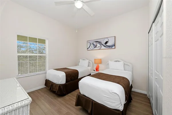 a bedroom with two beds and a window