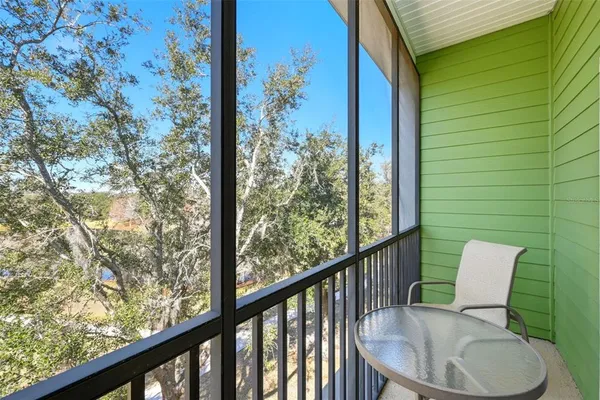 a view of a chair and table in the balcony