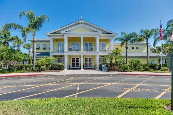 a front view of a house with a yard and potted plants