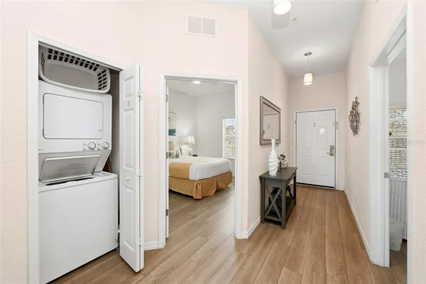 a view of a bedroom with a bed and wooden floor