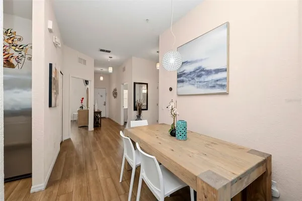 a view of a kitchen area with furniture and wooden floor
