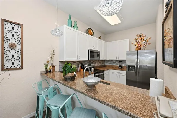 a kitchen with a refrigerator and microwave