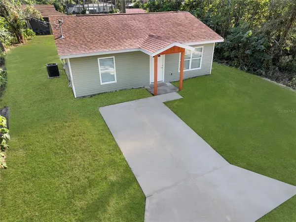 a aerial view of a house with a garden and yard
