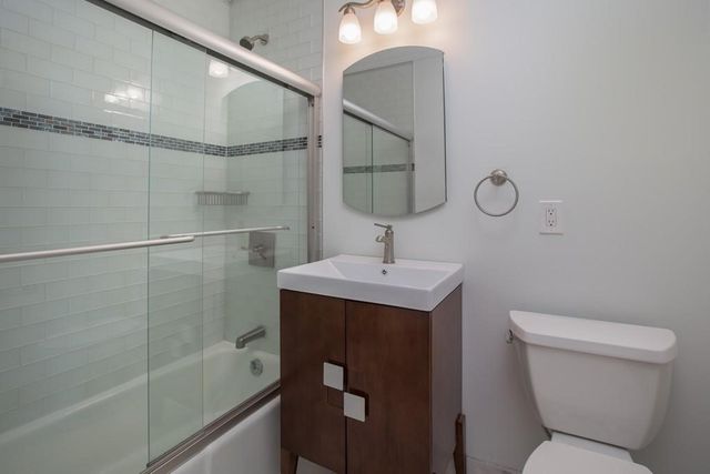 a bathroom with a toilet sink and shower