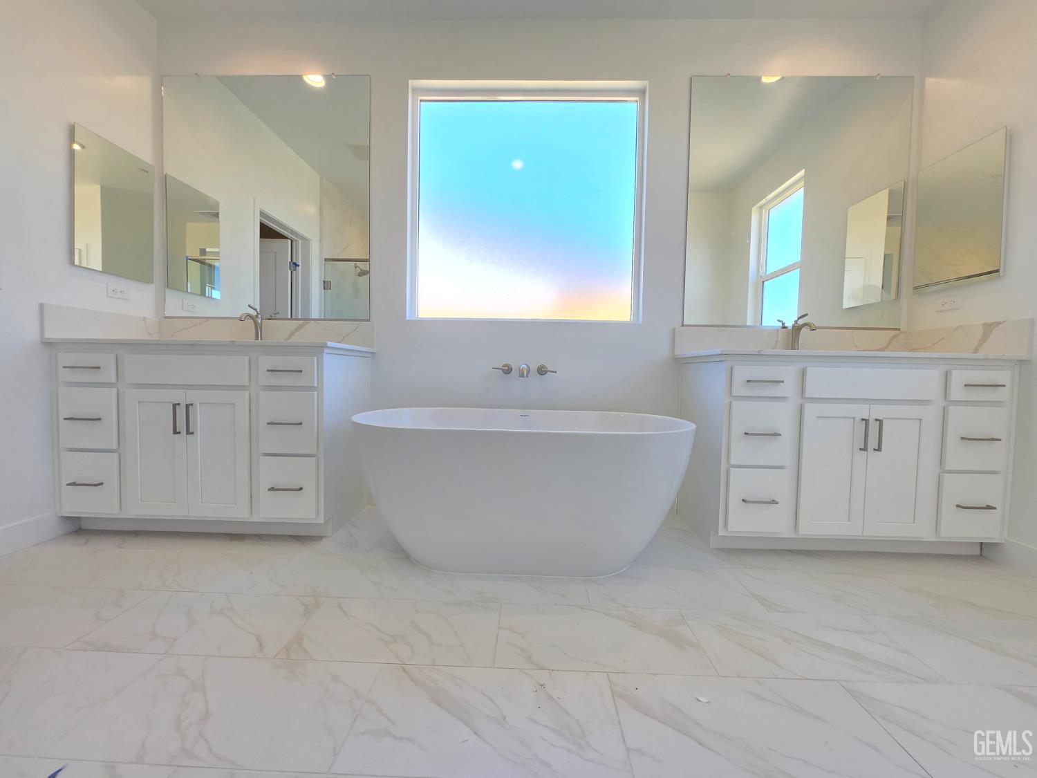 Undisclosed Address Bakersfield, CA 93306 - Photo 12 of 21 a spacious bathroom with a double vanity sink mirror and bathtub