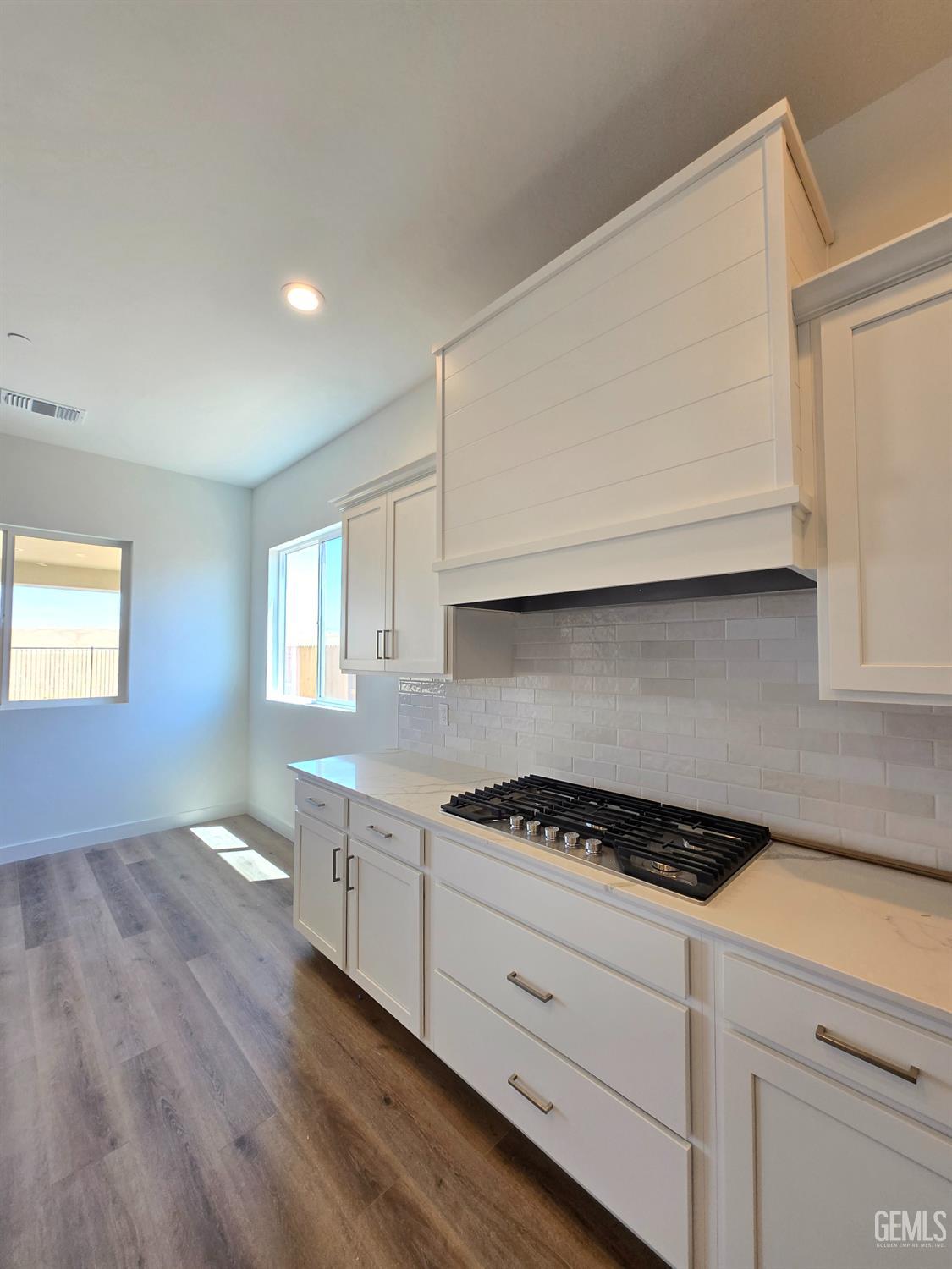 Undisclosed Address Bakersfield, CA 93306 - Photo 4 of 21 a kitchen with granite countertop white cabinets and white appliances