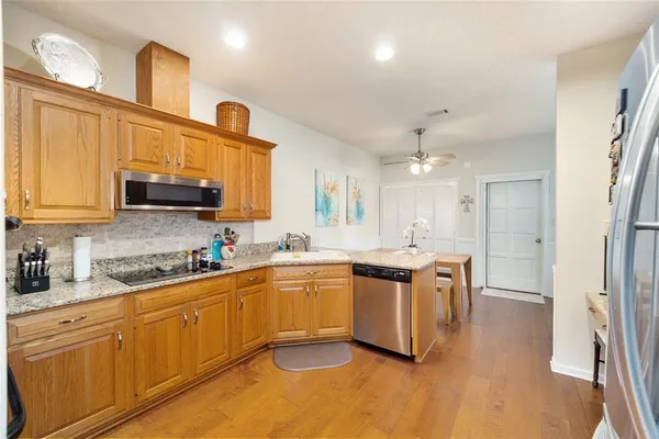 a kitchen with stainless steel appliances granite countertop a sink and cabinets