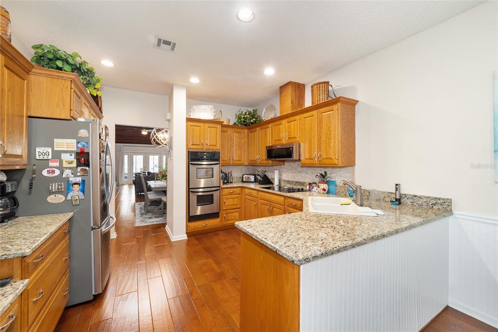 1731 Southeast Clatter Bridge Road Ocala, FL 34471 - Photo 13 of 52 a kitchen with stainless steel appliances granite countertop a sink refrigerator and cabinets