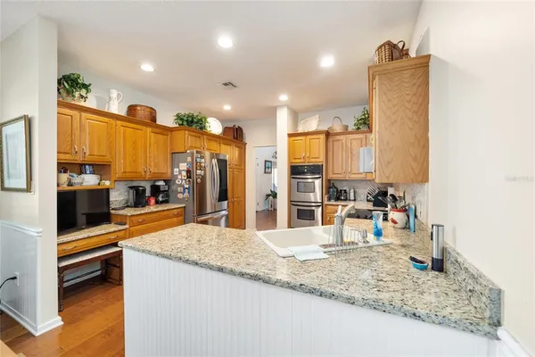 a kitchen with stainless steel appliances granite countertop sink and dishwasher